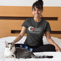 Image shows Dead Space Concordance Extraction Corporation Tee worn by female model facing front while sitting on a bed. Product features a coversitched collar and sleeves with side seams and shoulder to shoulder taping.