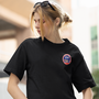 Image shows Dead Space Ishimura Crew Tee worn by female model facing front at an angle. Product is side-seamed and tightly knit.
